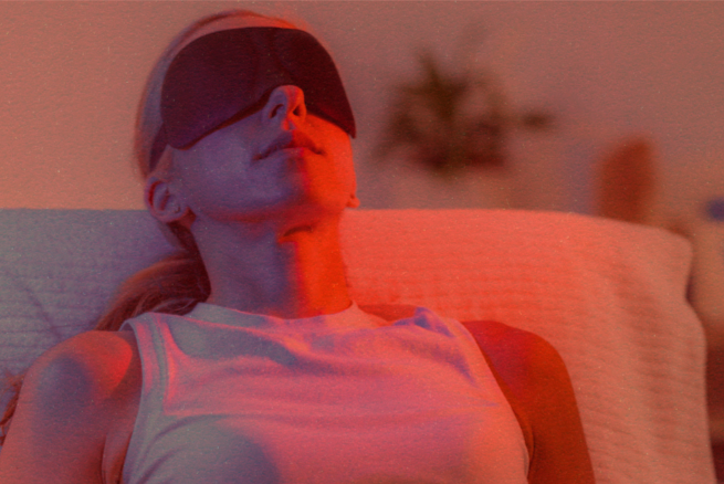 Woman wearing eye protection while receiving pulsed red light therapy.