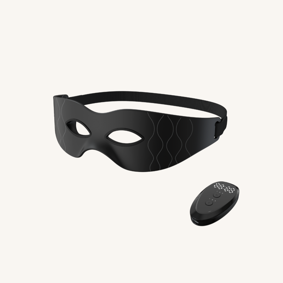 Black eye mask with a remote control on a white background